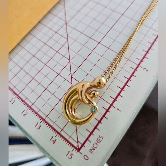 Goldtone Mother holding child with December Birthstone Fashion Necklace - Picture 4 of 4